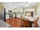 Eat-in kitchen with stainless appliances, wood floors, ceiling fans and ample cabinet space at 4553 Pond Ln, Marietta, GA 30062
