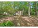 Backyard storage shed with double door and pathway, offering practical storage solutions in a wooded setting at 4553 Pond Ln, Marietta, GA 30062