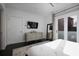 Bedroom with a large bed, dresser, television, and sliding glass doors to an outdoor balcony at 504 Rankin Ne St # 4, Atlanta, GA 30308
