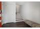 Bright foyer with a sleek bench seat, modern staircase, and stylish front door at 504 Rankin Ne St # 4, Atlanta, GA 30308