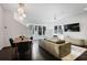 Well-lit living room with dining area features modern lighting, dark wood floors, and neutral decor at 504 Rankin Ne St # 4, Atlanta, GA 30308