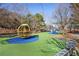 Community playground with slides, climbing structures, and benches on blue and green safety surface at 504 Rankin Ne St # 4, Atlanta, GA 30308