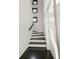 Bright stairway with dark hardwood floors, white risers, and modern windows at 504 Rankin Ne St # 4, Atlanta, GA 30308