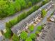 Aerial view of townhouses and a beautiful green space with mature trees and a winding road at 5317 Concordia Se Pl # 10, Mableton, GA 30126