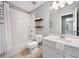 Bathroom with white tiled shower, vanity, and wood shelves at 5317 Concordia Se Pl # 10, Mableton, GA 30126