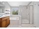 Bright bathroom with marble tiled floors, tub, and separate glass enclosed shower at 5317 Concordia Se Pl # 10, Mableton, GA 30126