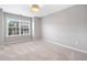 Light-filled carpeted bedroom with a large window and neutral walls at 5317 Concordia Se Pl # 10, Mableton, GA 30126