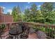 Relaxing outdoor deck with an ornate table and chairs surrounded by lush greenery and potted flowers at 5317 Concordia Se Pl # 10, Mableton, GA 30126