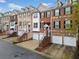 Street view of brick townhouses with attached garages and well-maintained landscaping at 5317 Concordia Se Pl # 10, Mableton, GA 30126