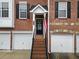 The exterior of the brick townhouse with black shutters and an American flag on the porch at 5317 Concordia Se Pl # 10, Mableton, GA 30126