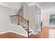 Hallway view with stairs, wooden handrail, and trim work at 5317 Concordia Se Pl # 10, Mableton, GA 30126