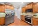 Modern kitchen features stainless steel appliances, wooden cabinets, and granite countertops at 5317 Concordia Se Pl # 10, Mableton, GA 30126