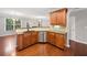 Stylish kitchen with wooden cabinets, granite countertops, and stainless steel dishwasher at 5317 Concordia Se Pl # 10, Mableton, GA 30126
