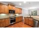 Well-equipped kitchen with stainless steel appliances, granite countertops, and wooden cabinetry at 5317 Concordia Se Pl # 10, Mableton, GA 30126