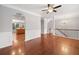 Spacious living room features hardwood floors, modern lighting, and an arched doorway to the kitchen at 5317 Concordia Se Pl # 10, Mableton, GA 30126