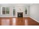 Bright living room featuring hardwood floors and a fireplace with white mantle at 5317 Concordia Se Pl # 10, Mableton, GA 30126