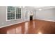 Cozy living room with hardwood floors, a fireplace, and bright windows at 5317 Concordia Se Pl # 10, Mableton, GA 30126