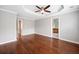 Spacious main bedroom with tray ceiling, hardwood floors, and an ensuite bathroom at 5317 Concordia Se Pl # 10, Mableton, GA 30126
