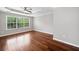 Spacious main bedroom with hardwood floors, ceiling fan, tray ceiling, and large windows for natural light at 5317 Concordia Se Pl # 10, Mableton, GA 30126