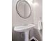 Classic powder room features a pedestal sink with decorative mirror and chrome fixtures at 5317 Concordia Se Pl # 10, Mableton, GA 30126