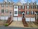 Charming brick townhouse with white garage doors and beautiful architectural details on a sunny day at 5317 Concordia Se Pl # 10, Mableton, GA 30126