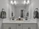 Bright bathroom featuring a large mirror, double sink vanity, and neutral decor at 5382 Pebblebrook Se Ln, Mableton, GA 30126