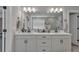 Bright bathroom featuring a large mirror, double sink vanity, and black hardware at 5382 Pebblebrook Se Ln, Mableton, GA 30126