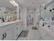 Bright bathroom featuring marble floors, soaking tub, glass shower and double sink vanity at 5382 Pebblebrook Se Ln, Mableton, GA 30126