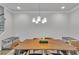 Contemporary dining room boasts a wooden table, modern lighting, and neutral decor at 5382 Pebblebrook Se Ln, Mableton, GA 30126