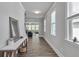 Hallway featuring wood floors, white trim, and a view into the living area and staircase at 5382 Pebblebrook Se Ln, Mableton, GA 30126