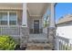 Inviting front porch with stone pillars, steps, and a gray front door, creating a welcoming entrance at 5382 Pebblebrook Se Ln, Mableton, GA 30126