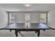 Spacious game room features a ping pong table for recreational activities at 5382 Pebblebrook Se Ln, Mableton, GA 30126