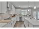 Bright kitchen with an island, white cabinets, stainless appliances, and modern lighting at 5382 Pebblebrook Se Ln, Mableton, GA 30126