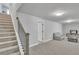 Carpeted living room features a staircase, comfortable seating, and recessed lighting at 5382 Pebblebrook Se Ln, Mableton, GA 30126
