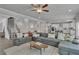 Expansive living room featuring a large sofa and a staircase to the left at 5382 Pebblebrook Se Ln, Mableton, GA 30126