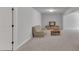 Spacious carpeted living room featuring a comfortable couch, coffee table, and ample lighting at 5382 Pebblebrook Se Ln, Mableton, GA 30126