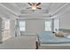 Spacious main bedroom features a tray ceiling, plush carpet, and natural lighting at 5382 Pebblebrook Se Ln, Mableton, GA 30126