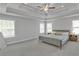 Bright main bedroom with a tray ceiling and plush carpet at 5382 Pebblebrook Se Ln, Mableton, GA 30126