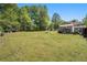 Expansive backyard with green grass, storage sheds, and room for gardening or recreation at 126 Amberwood Ln, Euharlee, GA 30145