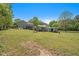 Wide angle of backyard with expansive yard space, shed, above ground pool and deck at 126 Amberwood Ln, Euharlee, GA 30145