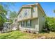 Two-story home with green siding, a green lawn, and multiple trees surrounding the house at 126 Amberwood Ln, Euharlee, GA 30145