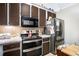 Kitchen featuring brown cabinets, stainless steel appliances, and tiled backsplash at 126 Amberwood Ln, Euharlee, GA 30145