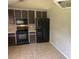 An eat-in kitchen shows dark appliances and tile floor at 126 Amberwood Ln, Euharlee, GA 30145