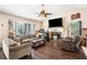 The living room features hardwood floors, a fireplace, sofas, chairs, and a ceiling fan at 126 Amberwood Ln, Euharlee, GA 30145