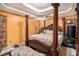 Bedroom featuring a four-poster bed, a floral comforter, and bedside tables at 126 Amberwood Ln, Euharlee, GA 30145