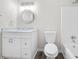 Bathroom features a modern vanity with marble countertop and a shower-tub combo at 3 S Riversong Ln, Alpharetta, GA 30022