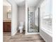 Bathroom featuring tile floors, large window, granite vanity, toilet and modern glass enclosed shower at 3 S Riversong Ln, Alpharetta, GA 30022