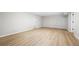 Bright bedroom featuring neutral walls, white trim and modern light vinyl floors at 3 S Riversong Ln, Alpharetta, GA 30022