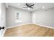 Bright bedroom featuring a ceiling fan, neutral walls, white trim and modern light vinyl floors at 3 S Riversong Ln, Alpharetta, GA 30022
