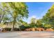 Residential property surrounded by mature trees and landscaping, enhancing curb appeal and privacy at 3 S Riversong Ln, Alpharetta, GA 30022